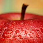 An apple covered with water droplets and text: health.